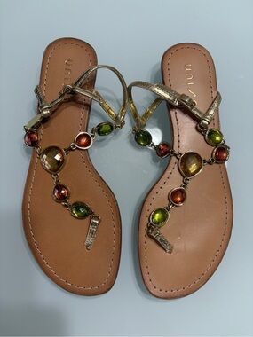 Unisa Gold T-Strap Sandals with Green & Amber Gems